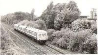 A 101 has left Lenzie for Falkirk and passes the Woodilee Institution.<br><br>[Brian Forbes //1980]