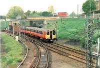 Eastbound train at Sunnyside Jct. The line in the foreground goes to Whifflet S.Jct. and the line under the bridge, to Gunnie yard & Gartsherrie. <br><br>[Brian Forbes //1999]