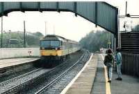 47709 rushes through Lenzie on an Edinburgh-Glasgow push-pull service in April 1985. A toilet plug is pulled which intrigues two young spotters.<br><br>[Brian Forbes /04/1985]