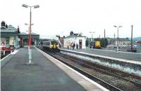 Unusual shot of a class 150 picking up in platform 9. The former NBR white building opened by the S&D Rly in 1852 was demolished 2001.<br><br>[Brian Forbes //1991]