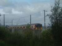 Class 318 318265 passes WH Malcolms Freight Terminal at Elderslie<br><br>[Graham Morgan 06/09/2006]