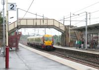 <I>'The Boys are Back in Town'</I> ... or soon will be!  Scene at Wishaw in August 2006 as an early evening train from Lanark, heading for Glasgow, arrives at platform 1. <br><br>[John Furnevel 11/08/2006]