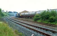 A pair of 20s head east with the Glasgow Airport aviation fuel empties from Hawkhead. This ran via the CGU to the E&G. Taken from the site of the original station. At the time this was the only traffic on the line west of Corkerhill Depot.<br><br>[Ewan Crawford //1990]