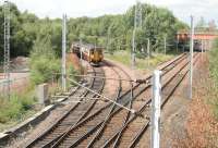 A Whifflet - Glasgow Central train at Whifflet North Junction in August 2006. The line to Coatbridge Central is on the right and the bridge that carried the Caledonian High Level line is in the right background.<br><br>[John Furnevel 24/08/2006]