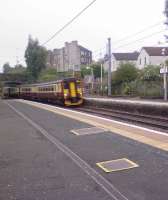 Stranraer bound class 156 units race through Johnstone station<br><br>[Graham Morgan 26/08/2006]