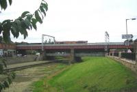 EWS 66073 brings northbound coal empties over the A89 and the Monkland Canal basin on the approach to Coatbridge Central in August 2006. Note the sign for Summerlee Heritage Museum on the right.<br><br>[John Furnevel 29/08/2006]