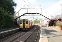 Colourful scene at Neilston station on 20 August 2006 as a terminating service arrives from Glasgow Central. Unit 314202 is the last train to carry SPT orange and black livery. Shame.<br><br>[John Furnevel 20/08/2006]