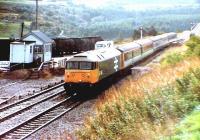 47641 passing Culloden cabin northbound to Inverness hauling a push pull set from the wrong end. The tar in the tanks to the left was heated before being reloaded into road tankers. Thus the haze.<br><br>[Brian Forbes //1988]