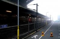 Platforms 20 & 21 seen through the early Sunday morning fog under the North Bridge, with only a Coke machine and the coned-off outline of a previous nights murder victim for company. View east from the car park on 17 September 2006. <br><br>[John Furnevel 17/09/2006]