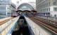 Canary Wharf station on the Docklands Light Railway amidst the various office blocks which now cover the area. Down below through the gap lies a small reminder of what once dominated this part of London. <br><br>[John Furnevel /07/2005]
