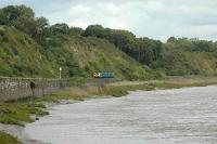 East of Lydney a Sprinter heads for Gloucester alongside the River Severn. The site of the large bridge which once crossed the river is behind the camera.<br><br>[Ewan Crawford 13/09/2006]
