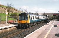 A Trans-Clyde 107 stops on a Glasgow -Falkirk local service. The new concrete bridge hides the old road bridge which was too narrow for the amount of road traffic.<br><br>[Brian Forbes //1988]