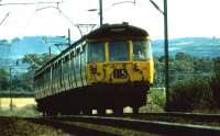 A Helensburgh bound pair of 303s pass the site of the Ardmore yard in August 1975.<br><br>[John McIntyre /08/1975]