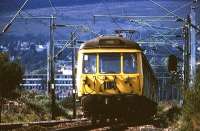 With Craigendoran and Helensburgh in the background a Class 303 heads east passed Ardmore West LC in August 1975.<br><br>[John McIntyre /08/1975]