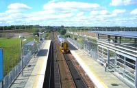 An eastbound service arriving at Edinburgh Park in September 2006. Taken through a window on the pedestrian overbridge.<br><br>[John Furnevel 08/09/2006]