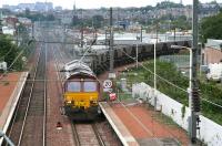 Westbound coal empties coming off the link from the sub at Slateford Junction on 26 September 2006 about to run west through Slateford station. In the background work continues on preparation of the new stabling roads for First ScotRail on the north side of Slateford Yard.<br><br>[John Furnevel 26/09/2006]