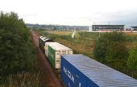<I>Here we go, here we go, here we go...</I>. A container train, having just left WHM, Grangemouth, passes Falkirk football stadium heading west towards Grahamston in September 2006.<br><br>[John Furnevel 21/09/2006]