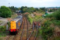 Two 37s and a 20 (all DRS) belt through Dalston passing gangers and oil from Grangemouth. Probably en route to Kingmoor.<br><br>[Ewan Crawford 27/09/2006]