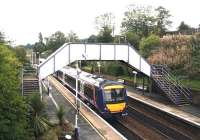 The ever-so-slightly exotic (even in the rain) east end of Polmont station with an Edinburgh service pulling away in September 2006. <br><br>[John Furnevel /09/2006]