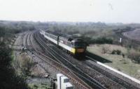 47711 rushes downhill between Greenhill Upper and Lower Junctions. Note one coach in Blue/grey. The Caledonian mainline runs down the right side of the shot.<br><br>[Brian Forbes //1988]