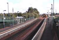 View of the modern station. The former Falkirk Camelon station, which was an island platform now overgrown, is passed by a 158 on the down line.<br><br>[Brian Forbes 23/09/2006]