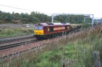 13.55 Dalzell - Lackenby steel flats approaching Carstairs in October 2006 behind 60097.<br><br>[John Furnevel 06/10/2006]