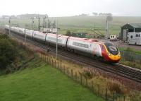 A Pendolino cuts through the rain on the southern approach to Carstairs in October 2006.<br><br>[John Furnevel 06/10/2006]