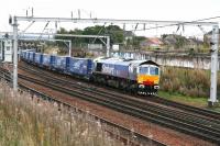 Stobart Rail 66411 <I>Eddie the engine</I> brings the Tesco containers north through Carstairs on 6 October 2006.<br><br>[John Furnevel 06/10/2006]