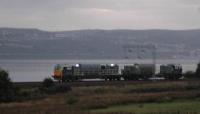 The 'Leaf Train' (as I call it) heads west to Helensburgh. This cute little train magically appears every Autumn to clear away fallen leaves.<br><br>[Beth Crawford 13/10/2006]