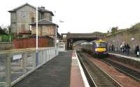 Edinburgh bound train arriving at Markinch on 201006. The train in the background has terminated here and is waiting to use the crossover. Behind the barriers work is underway in the old yard on the upgrade of the station and creation of a transport interchange.<br><br>[John Furnevel 20/10/2006]