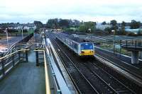 Londonderry service entering Antrim. In the background the (Bleach Green) line to Belfast passes under a roadbridge and to the right is the unused Crumlin route which passes very close to Belfast International Airport at Aldergrove.<br><br>[Ewan Crawford //]