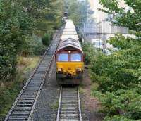 Loaded refuse containers destined for Oxwellmains head south out of Powderhall behind EWS 66233 on 27 October 2006.<br><br>[John Furnevel 27/10/2006]