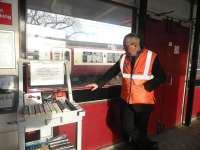 A novel idea! Michael Cochrane, a member of the ticket office staff at Shettleston, seen alongside the station book trolley on 24 November 2010 - see news item.<br><br>[First ScotRail 24/11/2010]