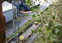 Cable haulage in use daily on a line in Edinburgh. The system is used at Powderhall depot to move the <I>Binliner</I> in order to position the required  container flats alongside the loading/unloading apron. Note the steel cable, to which the vehicles are attached, running from the winchroom on the left, looped through the anchored (yellow) boxes between the rails running to a return loop box at the end of the siding [see image 51074]. Photographed on 27 October 2006, with a loaded container visible top right.<br><br>[John Furnevel 27/10/2006]