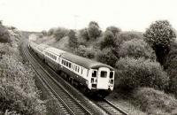 DMBS 604 heads the 1200 from Glasgow east to Edinburgh passing the former Woodilee Mental Hospital, with 47712 propelling at the rear.<br><br>[Brian Forbes //1985]