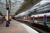 Looking north along the through platforms at Aberdeen in November 2006 with a train boarding for Inverness. The line behind the wire fence to the left is used for station bypass and train servicing movements.<br><br>[John Furnevel 05/11/2006]