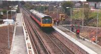 Construction of Greenfaulds station in 1989. The lookout man behind the train has whistled and shown a green flag to the driver of the 107 DMU which has slowed to 20mph. Destination Cumbernauld is 2 minutes away.<br><br>[Brian Forbes //1989]