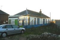 The listed station building at Oldmeldrum (renamed from Old Meldrum in 1902) photographed in November 2006, with the surrounding site in use as a garage. The wooden building appears to be in remarkably good condition considering the station closed in 1931. Approval has been obtained from Aberdeenshire Council and Historic Scotland to relocate this building to Milton of Crathes on the Deeside line. [See image 40765]  <br><br>[John Furnevel 06/11/2006]