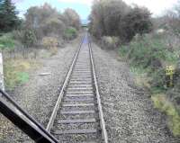 Site of Bridge of Earn Junction Oct 2006. Trackbed of the main line via Kinross bears right through the undergrowth while the remaining branch line via Ladybank continues straight ahead. Note change of mileage. <br><br>[Gary Straiton /10/2006]