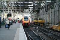 A Virgin Voyager for Birmingham New Street boarding at Waverley platform 10 on 25 November 2006 alongside some of the plant and equipment being used in the current reconstruction work.<br><br>[John Furnevel 25/11/2006]