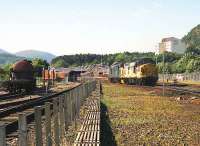 2 class 37s arrive at Aviemore from Inverness in the morning of 05 July 1991. One of the 37s will collect the Royal Scotsman coaching stock which can just be seen in the station.<br><br>[John McIntyre 05/07/1991]