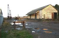 Entrance to the yard at Laurencekirk in November 2006 looking north with the old station just south of the goods shed on the right. The cranes are transferring pipes from rail to road transport.<br><br>[John Furnevel 11/11/2006]