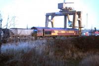 EWS 66078, having brought its load of imported Russian coal up the branch from Leith Docks, is held at signals at Portobello East Junction on 6 December 2006. The train is alongside the old Portobello Freightliner terminal awaiting the clear onto the ECML and the road to its ultimate destination, Cockenzie power station. Photograph taken from a passing train. <br><br>[John Furnevel 06/12/2006]