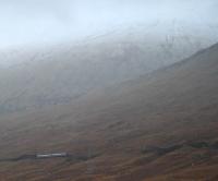 First of the Winter snows. In very unpleasant weather conditions a northbound Sprinter approaches Gorton. With rivers in spate and fallen trees from strong winds it is impressive services continued. Guala Mhor provides a cold backdrop.<br><br>[Ewan Crawford 05/12/2006]