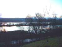 Just north of Kingussie all the farmland has disappeared under floodwater. In one area the railway embankment is the only dry land to be seen.<br><br>[John Gray 06/12/2006]