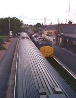 Looking south at Brora in August 1989 as a sprinter passes a northbound 37 hauled service.<br><br>[John McIntyre 15/08/1989]