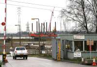 Entrance to the old yards at Kincardine on 15 December 2006. This has become a busy location handling traffic for both the reopening railway and the new bridge projects. Work on the foundations for the latter is being tackled by the rig <I>Seacore</I> in the background.<br><br>[John Furnevel 15/12/2006]