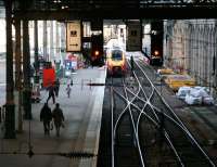 Passengers make their way along platform 10 on 16 December towards the 1105 Edinburgh - Bournemouth Virgin CrossCountry service boarding just beyond the southside crossover.<br><br>[John Furnevel 15/12/2006]