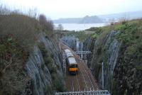 Bishopton Cutting and tunnels were cut into solid whinstone rock which delayed the opening of the line by 7 months. View looks west with a backdrop of the River Clyde and Dumbarton Castle.<br><br>[Ewan Crawford 03/01/2007]