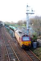 With plenty of power to spare the 67 from the sleeper takes empty oil tanks out of the sidings. This is a very complicated shunt involving many reversals. PS Who nicked my nice signal and replaced it with that new thing?<br><br>[Ewan Crawford 05/01/2006]